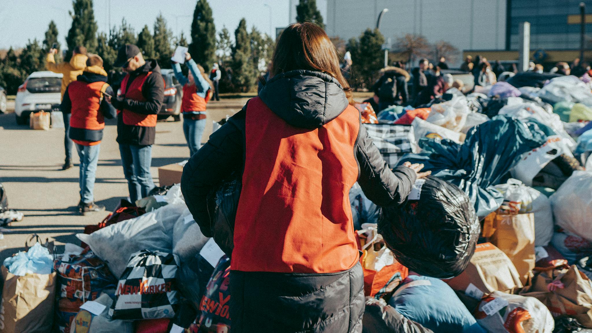 Community volunteers sort and organize clothing donations for charity in Vilnius, Lithuania.